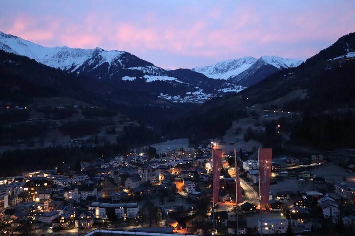 Dusk view over the town of Ilanz surrounded by snow-covered Swiss mountains